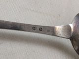 a spoon that has a small metal spoon on it