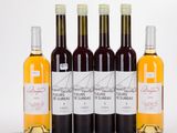 four bottles of wine sitting next to each other on a table