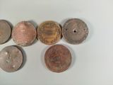 several different types of coins are arranged on a white surface