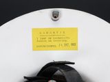 a white toilet with a black seat and a yellow tag on it