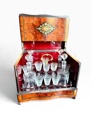 bottles and glasses in a wooden case on a white background