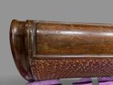a close up of a wooden object on a purple stand