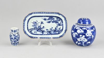 three pieces of blue and white pottery including a vase, a tray, and a vase