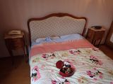 a bed with a pink and white comforter on it