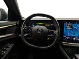 a steering wheel and dashboard of a car with a map on the screen