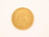 an image of a close up of a gold coin on a white surface