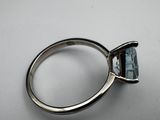 a close up of a ring with a blue stone in it