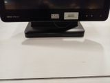 a small monitor on a stand on a table