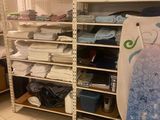 a room with a surfboard and a rack with towels on it