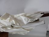 a white umbrella that has been folded up on a table