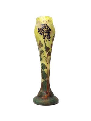 yellow and green vase with flowers and leaves on it on a white background