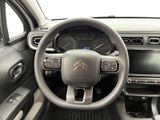 the interior of a car with a steering wheel and dashboard controls