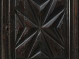 an old wooden cabinet with a star design on the door