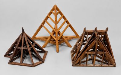 three pieces of wood are stacked on top of each other