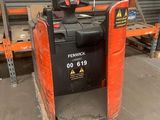 a forklift that is sitting in the middle of a warehouse