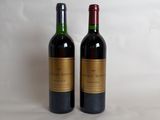 two bottles of wine sitting next to each other on a white surface