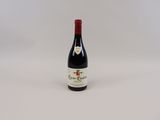 la bouteille de vin est posée sur une surface blanche