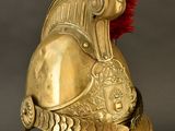 an antique helmet with a red mohawk on top of it