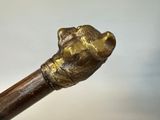 a close up of a walking stick with a hand on it