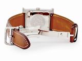 brown leather watch strap with a silver buckle on a white watch