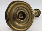 pair of antique brass candlesticks on a white background