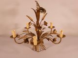 an image of a chandelier with candles and flowers on it