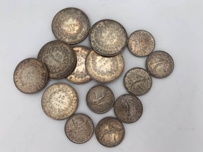 a pile of old coins sitting on top of a white surface