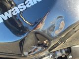 a close up of a motorcycle with the words kawasaki on it