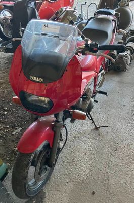 many motorcycles parked next to each other on the side of the road