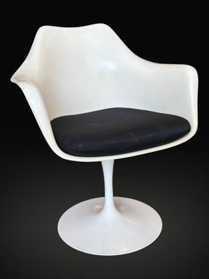 an image of a white chair with a black seat on a black background