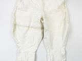 an old pair of white pants hanging on a white wall