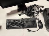 a keyboard, mouse, and monitor on a desk