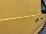 a yellow van that is parked in a parking lot