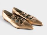 pair of gold ballet shoes on a white background