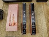 two boxes of makeup and a box of mascara on a table