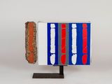 a red, white, and blue object on a stand