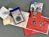two silver coins and a booklet are on a table
