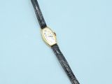 a close up of a wrist watch on a blue surface