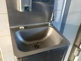 a stainless steel sink in a public restroom