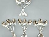 four silver spoons and two spoon spoons on a table
