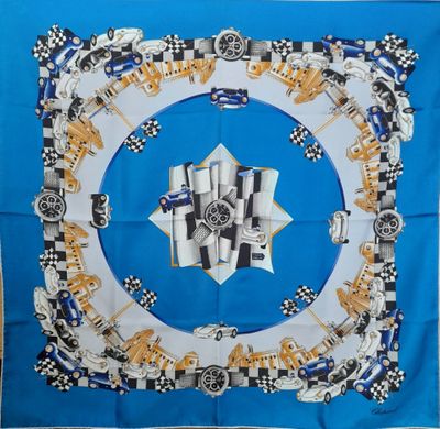 a close up of a blue and white square scarf with a picture of a car