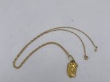 a gold necklace with a lion head on it