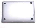 the back of a silver laptop computer sitting on top of a white surface