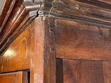 a large wooden cabinet with a mirror on top of it