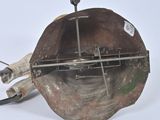 a metal object that is sitting on a white surface