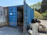 a blue shipping container sitting in the middle of a parking lot