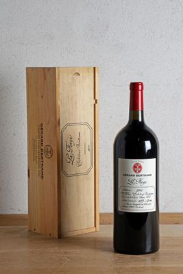 a bottle of wine sitting next to a wooden box