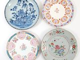 four plates with different designs on them on a white surface