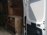 a white van with a door open and a table in the back