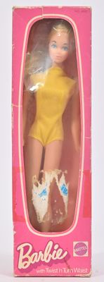 une poupée Barbie dans une boîte rose, vêtue d'un haut jaune et de chaussures bleues